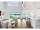 Open living room boasts high ceilings, waterfront views, and seamless access to the kitchen at 18824 Birchwood Groves Dr, Lutz, FL 33558