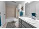 Clean bathroom featuring a bathtub and shower, a neutral color palette, and modern fixtures at 1948 Elaine Dr, Clearwater, FL 33760