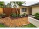 Landscaped front yard featuring mature trees, shrubbery, rocks, and colorful brick accents at 1948 Elaine Dr, Clearwater, FL 33760