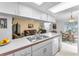 Bright kitchen opens to the living room with breakfast bar and views into the dining area at 1948 Elaine Dr, Clearwater, FL 33760