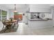 Bright kitchen features white appliances, tile floor, and a breakfast nook with sliding doors to patio at 1948 Elaine Dr, Clearwater, FL 33760