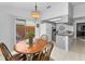 Bright eat-in kitchen features white appliances, tile floor, and sliding doors leading to a private patio at 1948 Elaine Dr, Clearwater, FL 33760