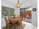 Bright breakfast nook features a round wood table and sliding glass doors to private patio at 1948 Elaine Dr, Clearwater, FL 33760