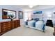 Comfortable main bedroom features soft blue walls, carpet flooring, and ample dresser space at 1948 Elaine Dr, Clearwater, FL 33760