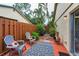 Private outdoor patio area with pavers, wooden fence, and comfortable seating at 1948 Elaine Dr, Clearwater, FL 33760