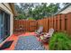 Private outdoor patio area with pavers, wooden fence, and comfortable seating at 1948 Elaine Dr, Clearwater, FL 33760