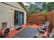 Private outdoor patio area with pavers, wooden fence, and comfortable seating at 1948 Elaine Dr, Clearwater, FL 33760