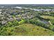 Scenic aerial view of houses in a community near a lake with lush greenery and trees at 19711 Wellington Manor Blvd, Lutz, FL 33549