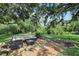 Relaxing brick patio featuring outdoor seating in a peaceful backyard setting at 19711 Wellington Manor Blvd, Lutz, FL 33549