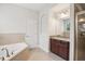 Bright bathroom featuring a soaking tub and vanity at 19711 Wellington Manor Blvd, Lutz, FL 33549