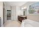 Spacious bathroom featuring a soaking tub, granite counters and neutral walls at 19711 Wellington Manor Blvd, Lutz, FL 33549