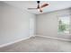 Bedroom features neutral carpet and a large window at 19711 Wellington Manor Blvd, Lutz, FL 33549