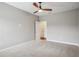 Neutral bedroom with carpet and two entry doors at 19711 Wellington Manor Blvd, Lutz, FL 33549