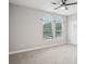 Spacious bedroom with neutral carpet and large windows offering natural light and a ceiling fan at 19711 Wellington Manor Blvd, Lutz, FL 33549