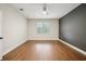 Bright bedroom features wood floors, a large window, and ample natural light at 19711 Wellington Manor Blvd, Lutz, FL 33549