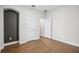 Vacant bedroom showcasing wood floors, neutral walls, and a closet; ready for personalization at 19711 Wellington Manor Blvd, Lutz, FL 33549