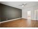 Spacious bedroom featuring hardwood floors, neutral walls, and modern ceiling fan at 19711 Wellington Manor Blvd, Lutz, FL 33549