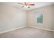 Carpeted bedroom with a window and ceiling fan at 19711 Wellington Manor Blvd, Lutz, FL 33549