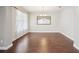 Dining room with wood-look floors, bright natural light, and a decorative mirror at 19711 Wellington Manor Blvd, Lutz, FL 33549