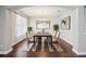 An elegant dining room showcases stylish furniture, chandelier, and wood flooring at 19711 Wellington Manor Blvd, Lutz, FL 33549