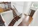 Elegant two-story foyer with staircase, dark wood floors, wrought iron railings, and natural light at 19711 Wellington Manor Blvd, Lutz, FL 33549
