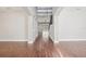 This foyer has archways, wood floors, and views of the staircase and pool at 19711 Wellington Manor Blvd, Lutz, FL 33549