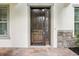 The home boasts a beautiful dark wood front door with stone accents at 19711 Wellington Manor Blvd, Lutz, FL 33549
