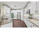Modern kitchen with stainless steel appliances, granite counters, and white cabinets at 19711 Wellington Manor Blvd, Lutz, FL 33549