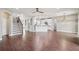 Open-concept living area with wood-look tile flooring adjacent to the staircase and kitchen at 19711 Wellington Manor Blvd, Lutz, FL 33549