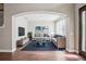 This well-lit living room has gray walls, wood floors, and neutral furniture at 19711 Wellington Manor Blvd, Lutz, FL 33549