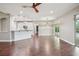 Wide angle shot of living room and kitchen with pool view via sliding glass door at 19711 Wellington Manor Blvd, Lutz, FL 33549