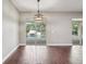 Open-concept living room with sliding doors to the pool area and views of waterfall feature at 19711 Wellington Manor Blvd, Lutz, FL 33549