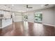 Spacious living room with a view of the kitchen and sliding glass doors leading to the pool area at 19711 Wellington Manor Blvd, Lutz, FL 33549