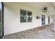 Covered patio area with brick pavers and ceiling fans, ideal for outdoor relaxation and entertainment at 19711 Wellington Manor Blvd, Lutz, FL 33549