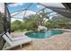 Gorgeous screened pool area with lush landscaping and a rock waterfall feature at 19711 Wellington Manor Blvd, Lutz, FL 33549