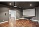 Home theater room features recessed lighting, a projector, and hardwood floors at 19711 Wellington Manor Blvd, Lutz, FL 33549