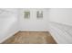 Walk-in closet with carpeted floors, wire shelving, and windows at 19711 Wellington Manor Blvd, Lutz, FL 33549