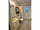 A small bathroom features a white toilet, sink, and vanity, and a bathtub with shower at 201 Lentz Rd, Brandon, FL 33510