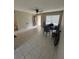 An empty living room features ceramic tile flooring, a ceiling fan, and one window with blinds at 201 Lentz Rd, Brandon, FL 33510