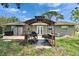 View of the patio area in the backyard featuring an outdoor grill and a manicured lawn, perfect for entertaining at 206 4Th Nw Ave, Ruskin, FL 33570