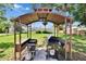Outdoor cooking area complete with grill, prepping area, and storage, set in a backyard with well-maintained lawn at 206 4Th Nw Ave, Ruskin, FL 33570