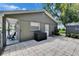 Secluded backyard patio with pavers, a storage shed, and shaded seating area at 206 4Th Nw Ave, Ruskin, FL 33570
