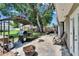 Covered outdoor grill area on the patio with chairs and spacious backyard including a privacy fence at 206 4Th Nw Ave, Ruskin, FL 33570