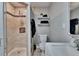 Bathroom with shower and neutral tile plus shelves for storage and white vanity at 206 4Th Nw Ave, Ruskin, FL 33570