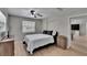 This well-lit bedroom features wood-look flooring, neutral walls, and ceiling fan at 206 4Th Nw Ave, Ruskin, FL 33570