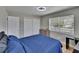 Bedroom with double door closet, desk and light wood-look floors at 206 4Th Nw Ave, Ruskin, FL 33570