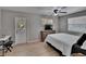 Bedroom with light wood-look floors, neutral paint, access door to outside and ceiling fan at 206 4Th Nw Ave, Ruskin, FL 33570