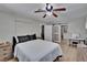 Well lit bedroom with neutral walls, light wood flooring, and barn door bathroom access at 206 4Th Nw Ave, Ruskin, FL 33570