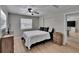 This well-lit bedroom features wood-look flooring, neutral walls, and ceiling fan at 206 4Th Nw Ave, Ruskin, FL 33570