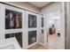 Walk in closet with mirrored doors and view into bedroom with light wood-look floors at 206 4Th Nw Ave, Ruskin, FL 33570